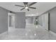 Open living space with gray walls, tile flooring, and a ceiling fan at 8132 W Pierson St, Phoenix, AZ 85033