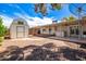 Large backyard with storage shed, covered patio, and low-maintenance gravel landscaping at 8310 E Glenrosa Ave, Scottsdale, AZ 85251