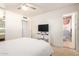 Cozy bedroom featuring a TV, a storage unit, and an en-suite bathroom at 8310 E Glenrosa Ave, Scottsdale, AZ 85251