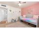 Bright and airy bedroom featuring pastel colored walls, ceiling fan, and a daybed at 8310 E Glenrosa Ave, Scottsdale, AZ 85251