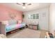 Cozy bedroom featuring pastel colored walls, a daybed, ceiling fan, and a cute accent rug at 8310 E Glenrosa Ave, Scottsdale, AZ 85251