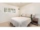 Neutral bedroom with a queen bed, end tables, and soft natural light at 8310 E Glenrosa Ave, Scottsdale, AZ 85251