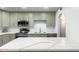 Well-lit kitchen with stainless steel appliances, a sleek island and arched doorway at 8310 E Glenrosa Ave, Scottsdale, AZ 85251