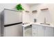 Kitchenette area featuring stainless steel refrigerator, cabinets, and a small countertop at 8310 E Glenrosa Ave, Scottsdale, AZ 85251