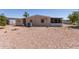 Large desert landscaped backyard featuring a storage shed and a covered patio at 8730 E Dewan Ave, Mesa, AZ 85208