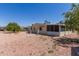 Spacious backyard featuring desert landscaping, patio, and a storage shed at 8730 E Dewan Ave, Mesa, AZ 85208