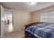Bedroom showcasing a closet, a window, wood-look flooring, and view of the living spaces at 8730 E Dewan Ave, Mesa, AZ 85208