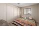 Bedroom with a closet, and a brightly colored patterned bed at 8730 E Dewan Ave, Mesa, AZ 85208