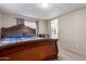 Bright bedroom with a queen bed and side table with an ensuite bathroom in view at 8730 E Dewan Ave, Mesa, AZ 85208
