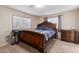 Bedroom with a queen-size bed, side table, neutral-toned walls, and two bright windows at 8730 E Dewan Ave, Mesa, AZ 85208