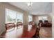 Dining area with a large window, connecting to the living room with wood-look flooring at 8730 E Dewan Ave, Mesa, AZ 85208