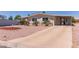 Single-story home featuring a long driveway, low-maintenance front yard, and covered parking at 8730 E Dewan Ave, Mesa, AZ 85208