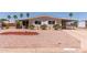 Inviting single-story home featuring a charming front yard and covered parking at 8730 E Dewan Ave, Mesa, AZ 85208