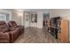 Open-concept living space with wood-look flooring, seamlessly connecting to the dining area at 8730 E Dewan Ave, Mesa, AZ 85208