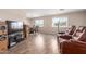Inviting living room featuring wood-look floors and large windows that fill the space with natural light at 8730 E Dewan Ave, Mesa, AZ 85208