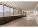 A covered patio featuring retractable sun shades, offering a versatile outdoor living space at 8730 E Dewan Ave, Mesa, AZ 85208