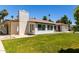 A backyard with lush grass, a white brick chimney, and a covered patio area at 9436 N 41St Dr, Phoenix, AZ 85051
