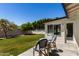 A patio with a table and seating in a grassy backyard at 9436 N 41St Dr, Phoenix, AZ 85051