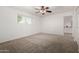 Bright bedroom features neutral carpet, a ceiling fan, and a closet at 9436 N 41St Dr, Phoenix, AZ 85051