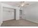 A carpeted bedroom with an open closet and a doorway leading to the bathroom at 9436 N 41St Dr, Phoenix, AZ 85051