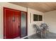 Cozy front porch with a red door and seating area, perfect for enjoying the outdoors at 9436 N 41St Dr, Phoenix, AZ 85051