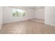 Bright living room with tile flooring, a raised platform area, and a large window at 9436 N 41St Dr, Phoenix, AZ 85051