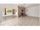 Bright living room boasts a brick fireplace, tile floors, and access to a sunroom at 9436 N 41St Dr, Phoenix, AZ 85051