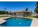 An in-ground pool with a large backyard and an open patio with chairs at 9436 N 41St Dr, Phoenix, AZ 85051