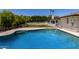 Sparkling pool with lush landscaping and a spacious deck perfect for outdoor relaxation and entertaining at 9436 N 41St Dr, Phoenix, AZ 85051