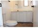 A bathroom with a toilet and a vanity offers essential facilities in a home at 9501 E Broadway Rd # 254, Mesa, AZ 85208