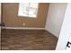 Simple bedroom with laminate flooring, natural light, and neutral walls at 9501 E Broadway Rd # 254, Mesa, AZ 85208