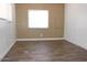 Cozy bedroom featuring wood-look flooring, a window, and neutral wall colors at 9501 E Broadway Rd # 254, Mesa, AZ 85208