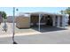 Exterior view of a home featuring a covered carport and mature landscaping at 9501 E Broadway Rd # 254, Mesa, AZ 85208
