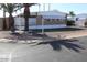 A single-story home has mature landscaping with palm trees enhancing curb appeal at 9501 E Broadway Rd # 254, Mesa, AZ 85208