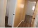 Hallway featuring neutral wall colors, white trim, and wood-look flooring at 9501 E Broadway Rd # 254, Mesa, AZ 85208
