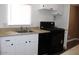 Functional kitchen area with white cabinetry and black appliances at 9501 E Broadway Rd # 254, Mesa, AZ 85208