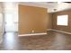 Open living room with laminate flooring, a ceiling fan, and a bright window at 9501 E Broadway Rd # 254, Mesa, AZ 85208