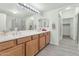Bright bathroom featuring double sinks, tile floors, a large mirror, and a separate shower and toilet room at 955 E Knox Rd # 137, Chandler, AZ 85225