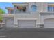 Exterior view of a condo showcasing well-maintained garages and balcony with neutral color scheme and tile roof at 955 E Knox Rd # 137, Chandler, AZ 85225