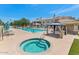 Community pool and spa area including a covered seating area on a sunny day at 955 E Knox Rd # 137, Chandler, AZ 85225