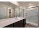 Modern bathroom with sleek vanity, large mirror, and glass enclosed shower, showcasing contemporary design and functionality at 1050 W West Virginia Ave, Florence, AZ 85132
