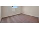 Bright bedroom featuring neutral walls, carpet, and a window letting in natural light at 1050 W West Virginia Ave, Florence, AZ 85132