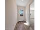 Bright entryway with wood-look floors, and a front door with a decorative glass window at 1050 W West Virginia Ave, Florence, AZ 85132