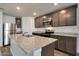 A modern kitchen features granite countertops, stainless steel appliances, and a kitchen island at 1050 W West Virginia Ave, Florence, AZ 85132