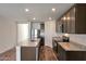This modern kitchen has stainless steel appliances, granite countertops, and wood-look flooring at 1050 W West Virginia Ave, Florence, AZ 85132