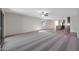 Open-concept living room with wood-look flooring and neutral paint colors at 1050 W West Virginia Ave, Florence, AZ 85132
