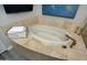 Relaxing bathroom with a luxurious soaking tub, neutral tile surround, and coordinated decor at 10841 N Mountain Vista Mtn, Fountain Hills, AZ 85268