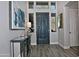 The home's foyer boasts an art display, hardwood floors, and a front door flanked by transom windows at 10841 N Mountain Vista Mtn, Fountain Hills, AZ 85268