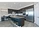Gourmet kitchen with stainless steel appliances, dark cabinetry, and a large center island with barstool seating at 10841 N Mountain Vista Mtn, Fountain Hills, AZ 85268