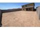 Large dirt backyard enclosed by concrete fencing, offering ample space for landscaping and recreation at 1091 W West Virginia Ave, Florence, AZ 85132